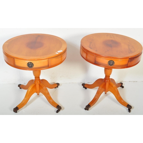 1505 - A pair of vintage 20th century Regency revival yew wood drum side tables. Each table having a circul... 