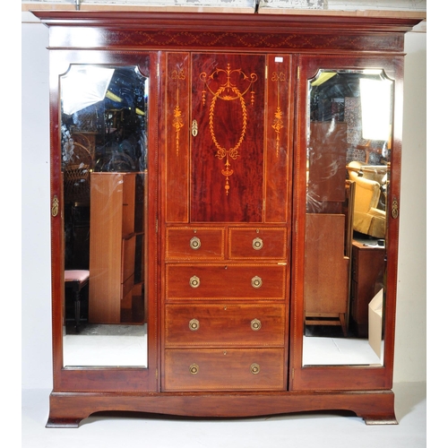 1515 - Edwardian mahogany inlaid triple wardrobe compactum. Raised on plinth base with triple section compr... 