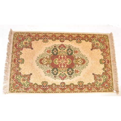 1521 - A vintage 20th Century Persian Islamic floor carpet rug. The lot to include a red, beige & green rug... 