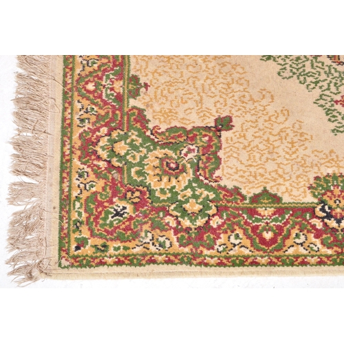 1521 - A vintage 20th Century Persian Islamic floor carpet rug. The lot to include a red, beige & green rug... 