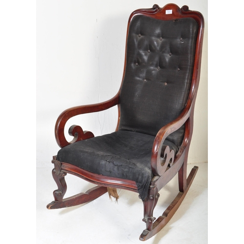 1523 - A 19th Century Victorian mahogany rocking arm chair. Having a long back rest with scrolled decoratio... 