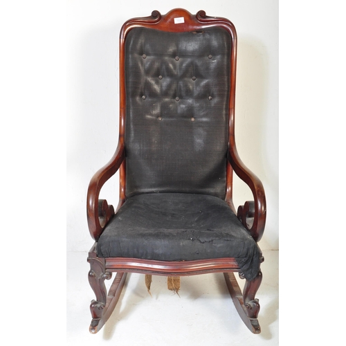 1523 - A 19th Century Victorian mahogany rocking arm chair. Having a long back rest with scrolled decoratio... 