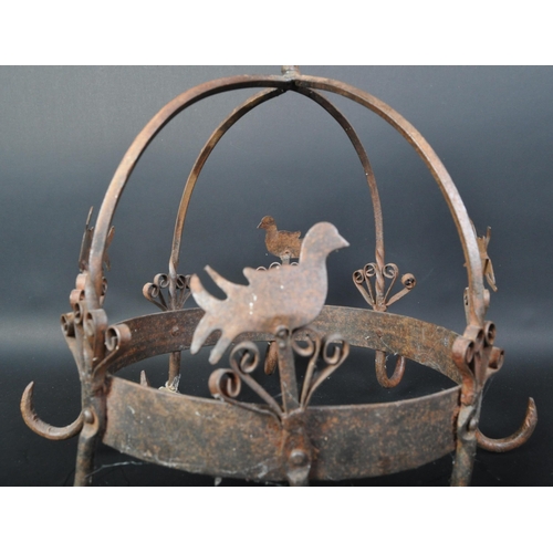 1541 - A Victorian 19th century hanging wrought iron metal pot hook rack with eight hooks and alternating b... 