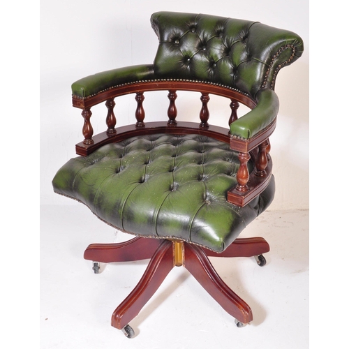 1542 - A 20th century Victorian Revival green leather Chesterfield Captains deep button back yew wood frame... 