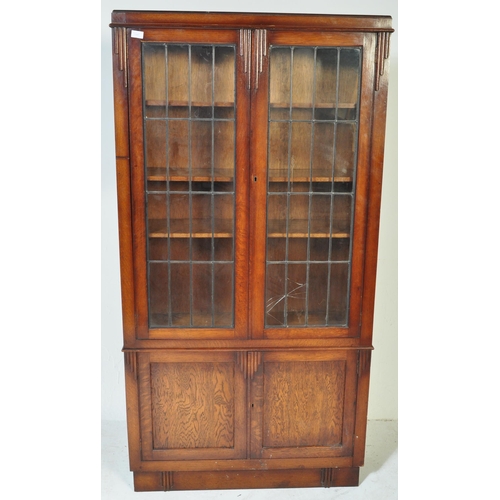 1547 - 1930's Art Deco oak and leaded glass library bookcase cabinet. Raised on plinth base with twin door ... 