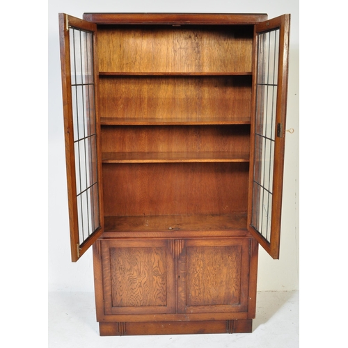 1547 - 1930's Art Deco oak and leaded glass library bookcase cabinet. Raised on plinth base with twin door ... 