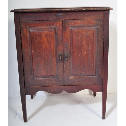 1550 - A 1920's oak Jacobean revival twin door music / hall cupboard being raised on tapering legs with twi... 