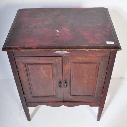 1550 - A 1920's oak Jacobean revival twin door music / hall cupboard being raised on tapering legs with twi... 