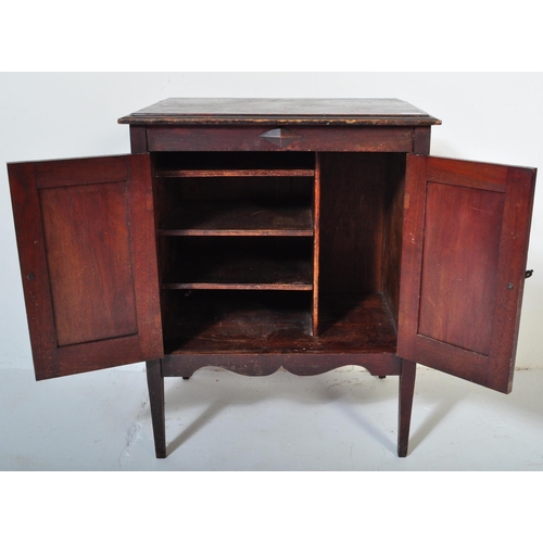 1550 - A 1920's oak Jacobean revival twin door music / hall cupboard being raised on tapering legs with twi... 