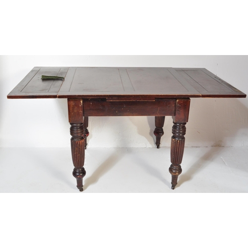 1551 - A 1930's mahogany draw leaf refectory dining table being raised on baluster reeded legs with castors... 