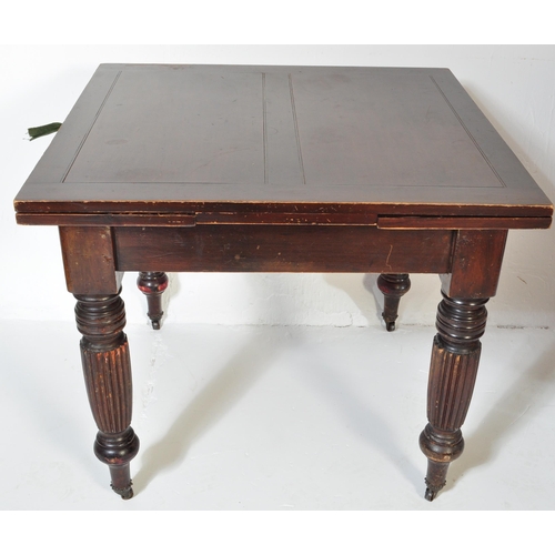 1551 - A 1930's mahogany draw leaf refectory dining table being raised on baluster reeded legs with castors... 