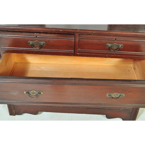 1553 - An Edwardian mahogany chest of drawers. Raised on plinth base with short and deep drawers having swi... 