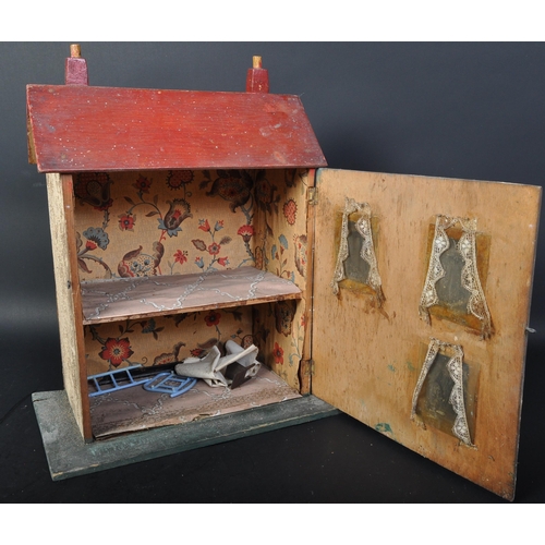 1556 - A 20th century scratch built hand painted wooden dolls house cottage. The front opening completely t... 