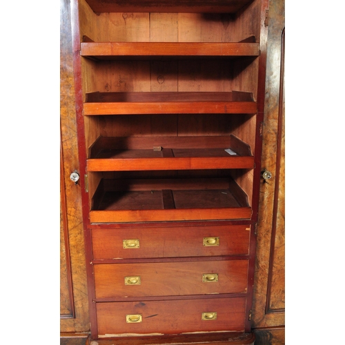 1562 - A Victorian 19th century burr walnut breakfront triple wardrobe. The wardrobe a central full length ... 