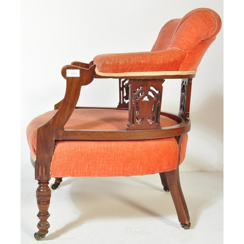 1570 - A 19th century Victorian mahogany tub armchair. Raised on turned legs with overstuffed seat and back... 