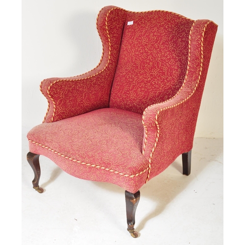 1576 - A Victorian 19th century wingback armchair. The armchair being having curved armrests with brocade t... 