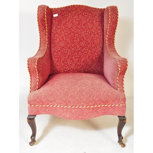 1576 - A Victorian 19th century wingback armchair. The armchair being having curved armrests with brocade t... 