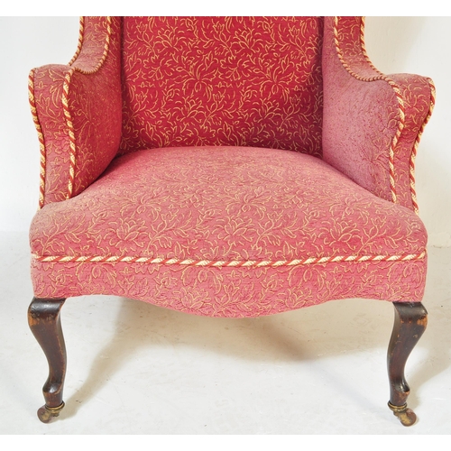 1576 - A Victorian 19th century wingback armchair. The armchair being having curved armrests with brocade t... 