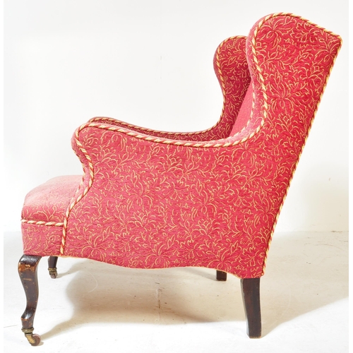 1576 - A Victorian 19th century wingback armchair. The armchair being having curved armrests with brocade t... 