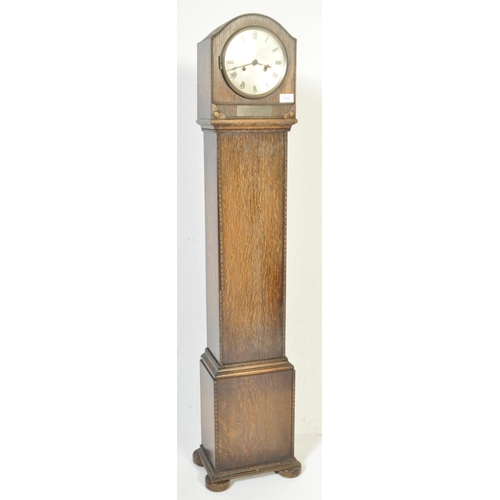 1594 - An early 20th century circa. 1920's / 1930's grandmother clock. The clock having a silvered face wit... 