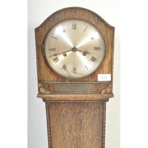 1594 - An early 20th century circa. 1920's / 1930's grandmother clock. The clock having a silvered face wit... 