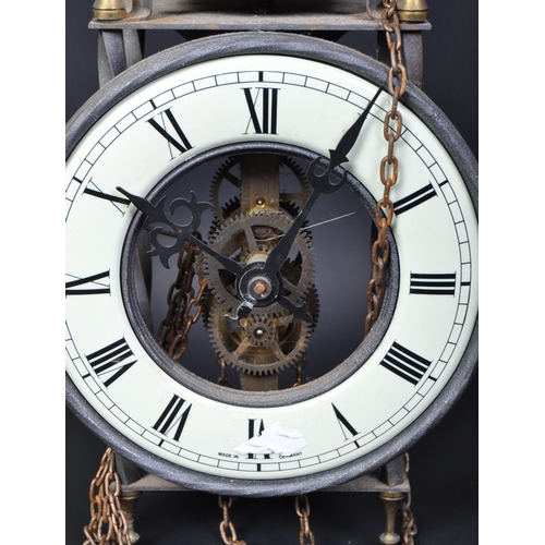 1596 - An early 20th century hanging skeleton clock. The clock having black enamelled roman numeral to the ... 