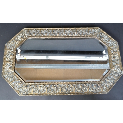 1603 - A Victorian late 19th century Art Nouveau repousse brass mirror of canted rectangular form with foli... 