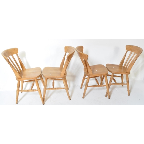 1610 - A set of four Victorian style pine farmhouse Windsor dining chairs. Having a curved backrest with ho... 