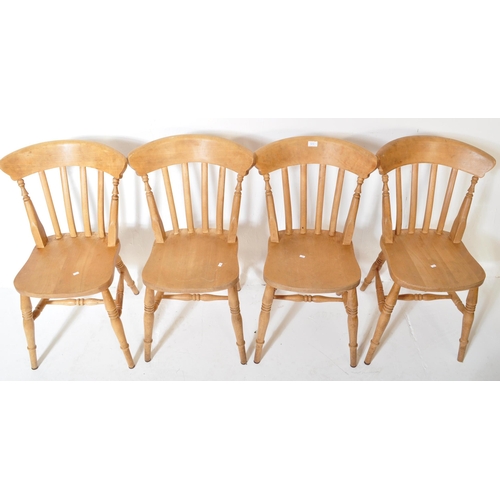 1610 - A set of four Victorian style pine farmhouse Windsor dining chairs. Having a curved backrest with ho... 