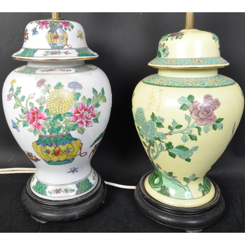 1614 - A pair of Chinese vase lamps. Famille rose and Famille Bleu grounds with floral sprays on wooden soc... 