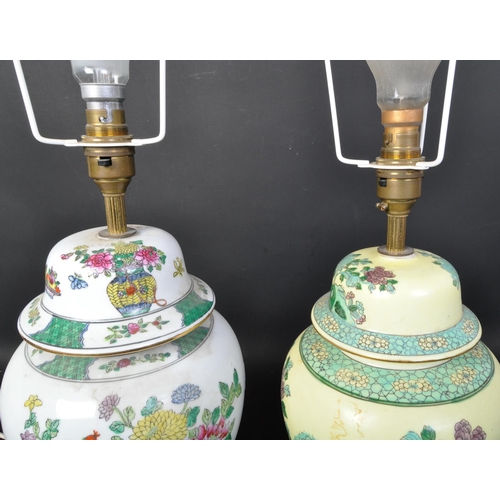 1614 - A pair of Chinese vase lamps. Famille rose and Famille Bleu grounds with floral sprays on wooden soc... 