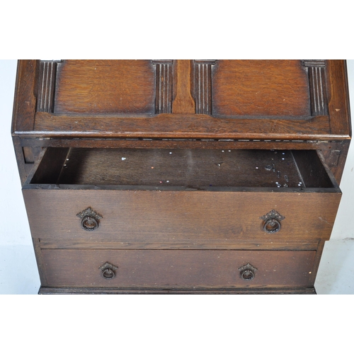 1619 - A 20th century Jacobean revival oak bureau desk. The bureau being raised on cup and cover carved leg... 