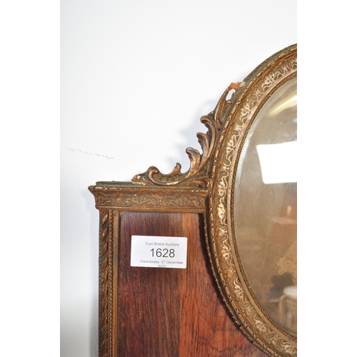 1628 - An early 20th Century wall hanging mirror. With gilt and rosewood border, portrait decoration to top... 