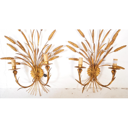 1632 - A pair of mid 20th century circa 1950s gilt metal wall shaped lights. Each lamp being shaped in the ... 