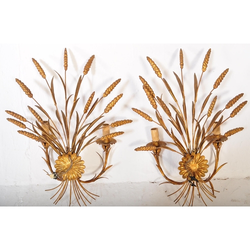 1632 - A pair of mid 20th century circa 1950s gilt metal wall shaped lights. Each lamp being shaped in the ... 