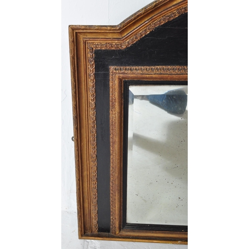 1633 - A Victorian 19th century ebonised & gilt wooden overmantel mirror. The mirror having an arched top w... 