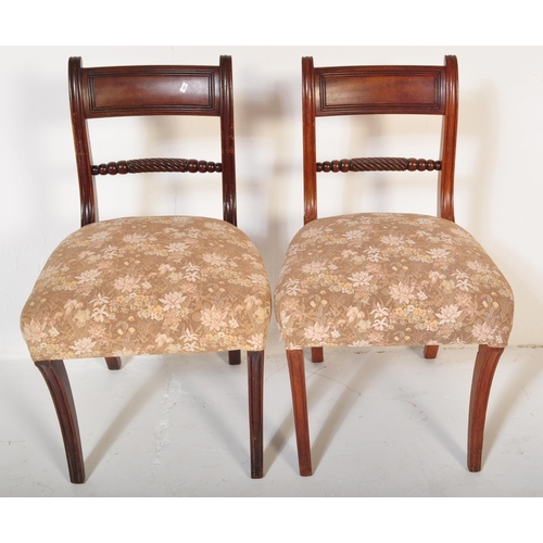 1657 - A pair of 19th century Regency mahogany bar back carver dining armchair. Raised on reeded tapering l... 