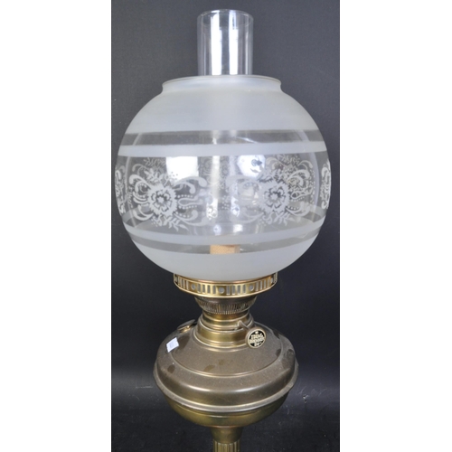 1687 - A Victorian 19th Century brass oil lamp. Having a brass fuel chamber supported on central column wit... 