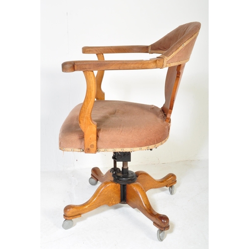 1688 - A vintage 1920's oak office / factory Industrial swivel chair having arched back with scrolled elbow... 