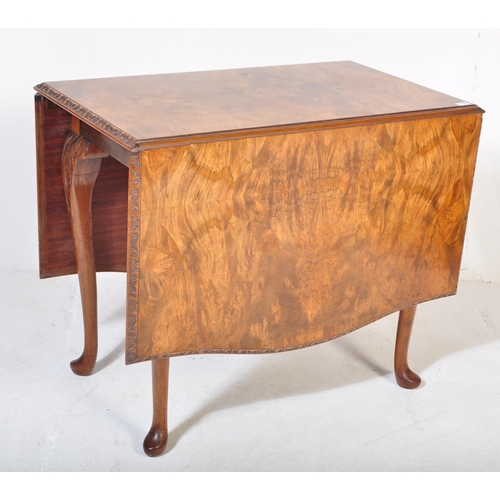 1692 - A 20th century Queen Anne Revival burr walnut drop leaf extending dining table having a straight top... 