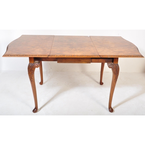 1692 - A 20th century Queen Anne Revival burr walnut drop leaf extending dining table having a straight top... 