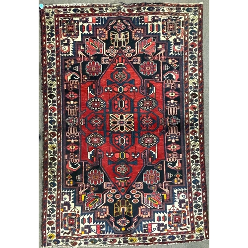 1820 - An 20th century Persian Islamic Bakhtar runner floor carpet rug having a central medallion with flor... 