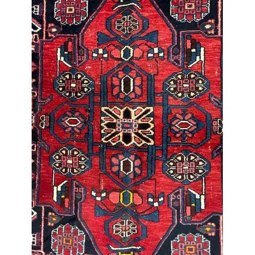 1820 - An 20th century Persian Islamic Bakhtar runner floor carpet rug having a central medallion with flor... 