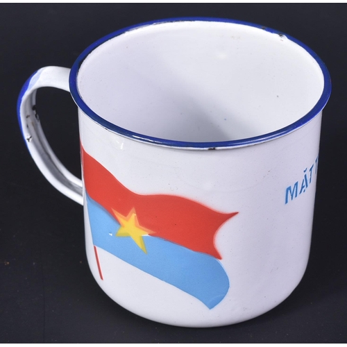 102 - A Vietnam War era rice cup dedicated to the Viet Cong. The white enamel cup with Viet Cong flag stri... 