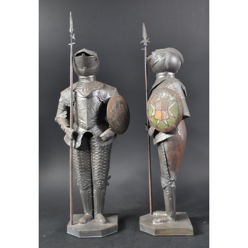 106 - A pair of vintage 20th Century pressed metal Maltese Knight figurines. The armoured figures with pol... 