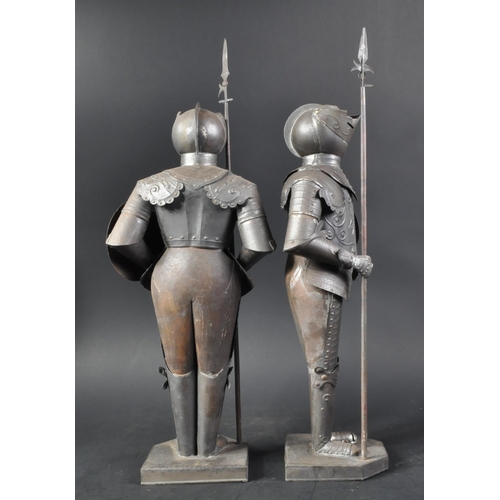 106 - A pair of vintage 20th Century pressed metal Maltese Knight figurines. The armoured figures with pol... 