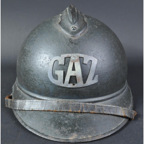 15 - A WWI First World War French M15 Adrian helmet with applied Gas Troop badge. The helmet of usual for... 