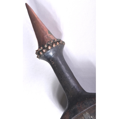 153 - An early 19th Century Central African / Congolese tribal dagger. The dagger having a copper dome sha... 