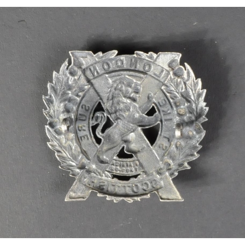 241 - A WWI First World War British London Scottish regiment silver cap badge. The badge depicting a Lion ... 