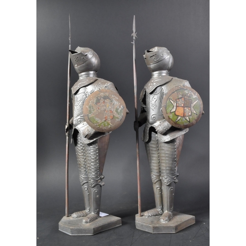 106 - A pair of vintage 20th Century pressed metal Maltese Knight figurines. The armoured figures with pol... 